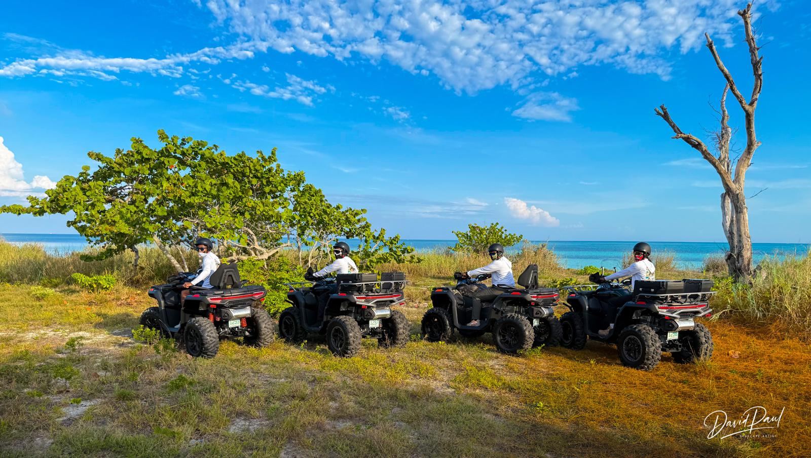 Four Bahama Blast ATVs lined up by the ocean in Nassau